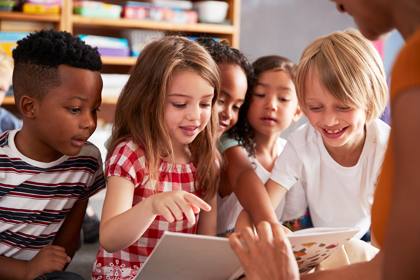 Children listening to a teacher during a classroom activity.